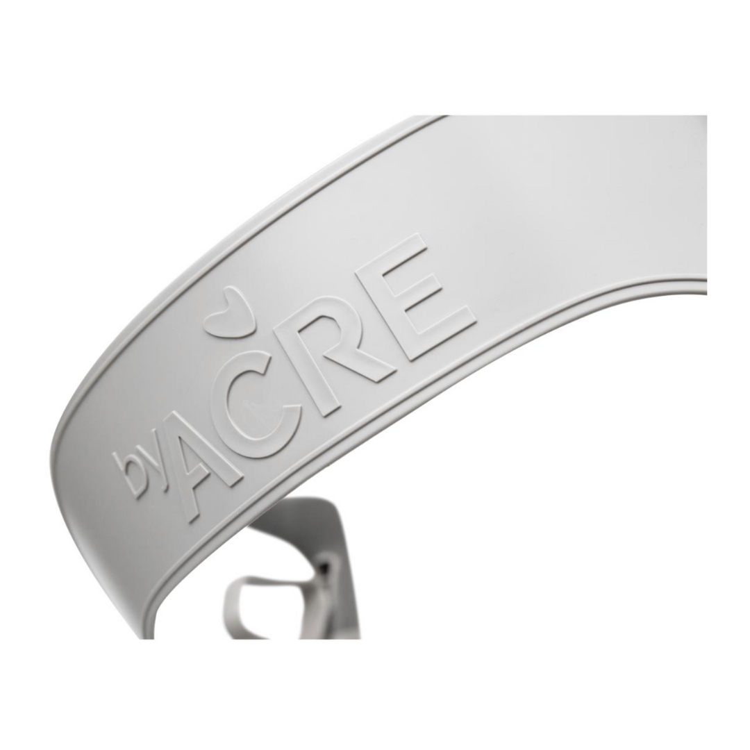 Close-up of the white ByAcre Accessories For The Ultralight Carbon Fiber Rollators with embossed text and a small heart-shaped symbol. The sleek design emphasizes quality and branding, featuring a stylish curved section in the background.